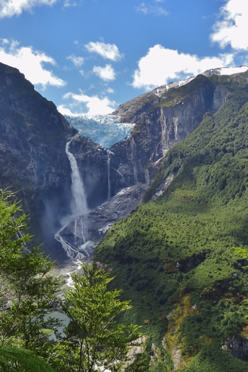 The stunning blue glacier and tall waterfall at Quelat National Park in Aysen, Patagonia